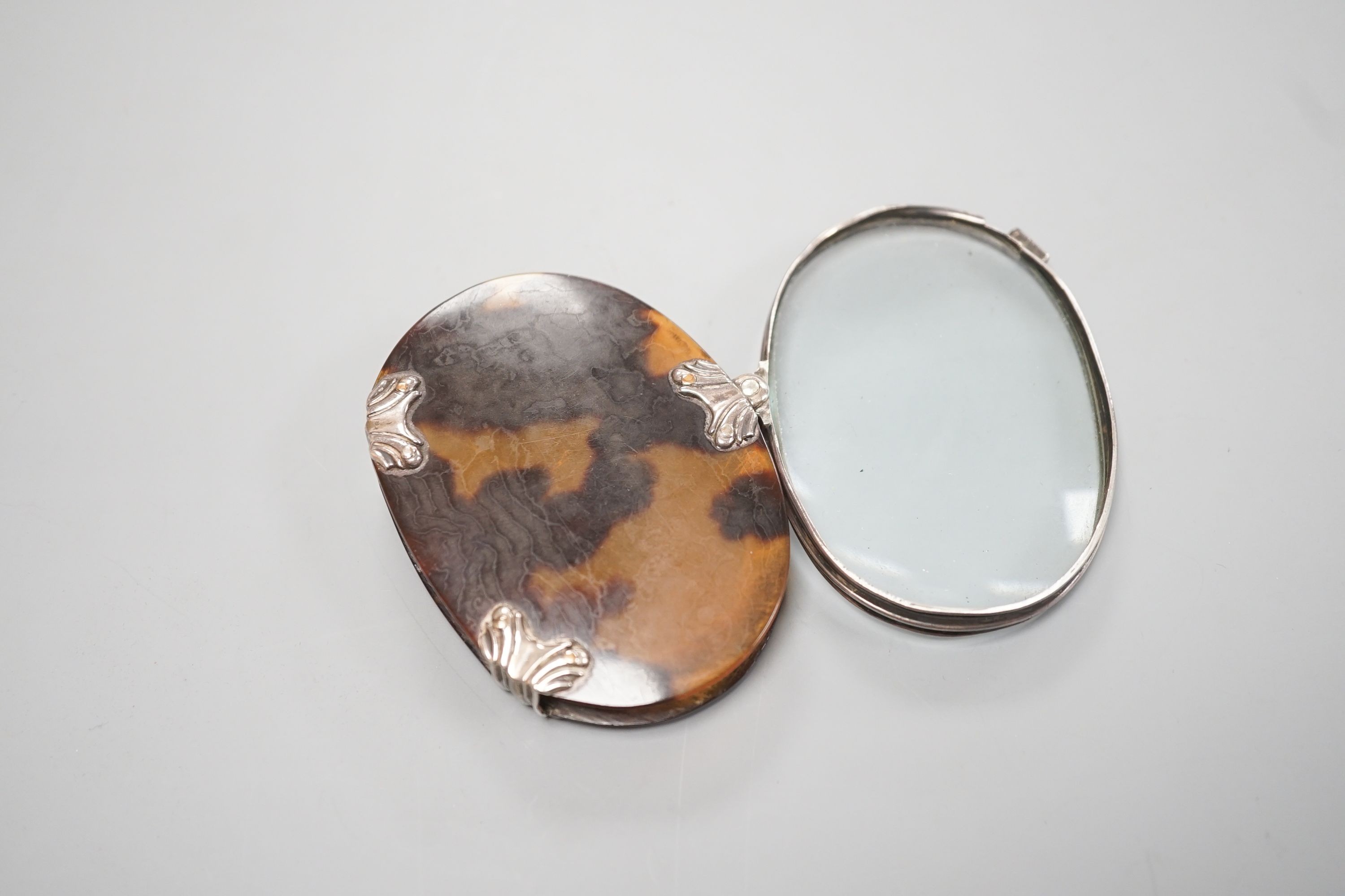 A 19th century white metal and tortoiseshell mounted folding magnifying glass, 73mm.